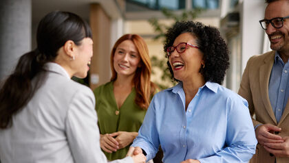 Diverse business colleagues shaking hands in a modern office