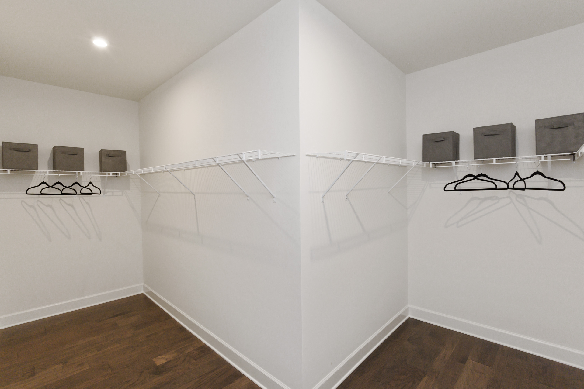 primary closet with divider and built in wire shelf
