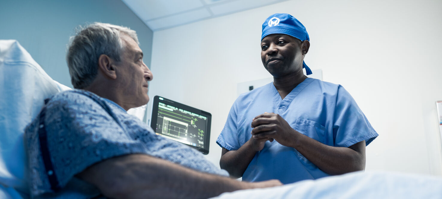 Dr. Etame speaks with a patient