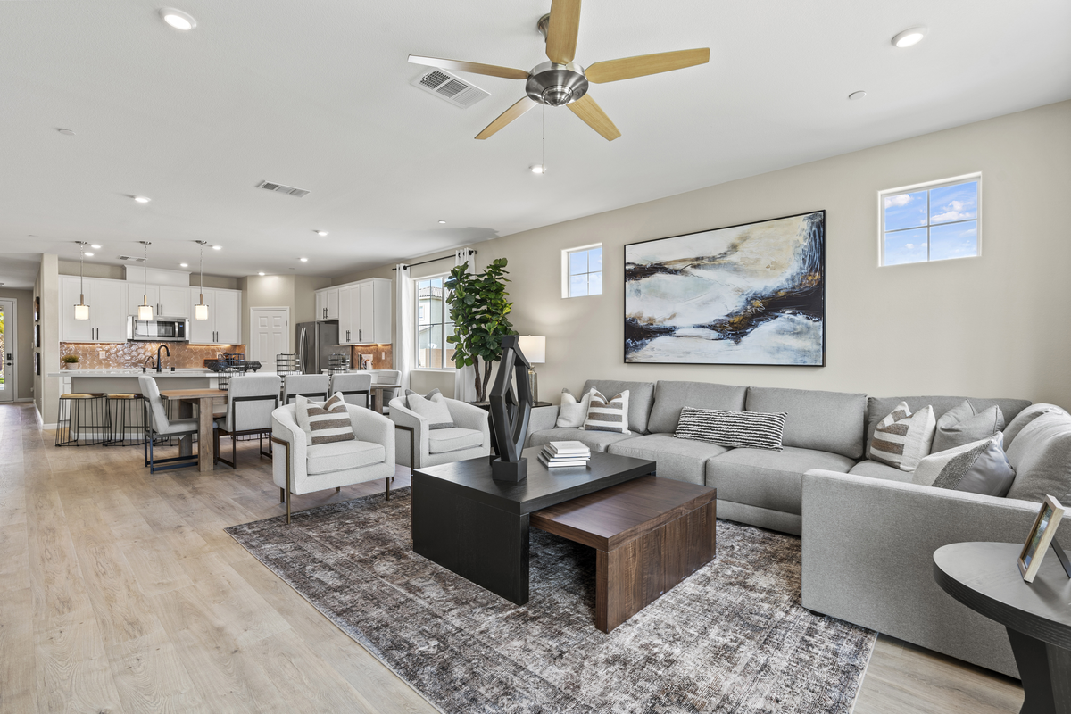 open great room with grey couche and natural light