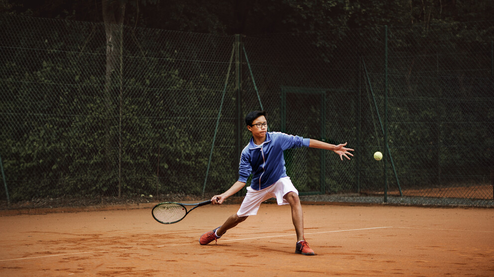 Man wearing special HOYA sport lenses while playing tennis