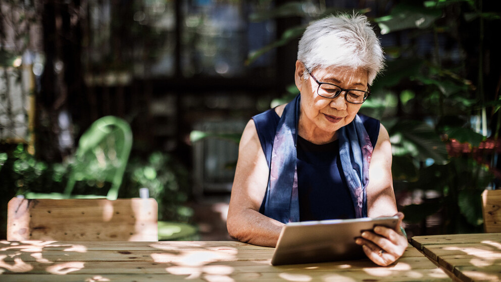 Older lady with glasses looking at tablet