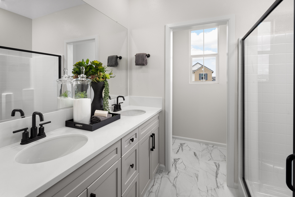 bathroom with tile flooring and gray cabinets