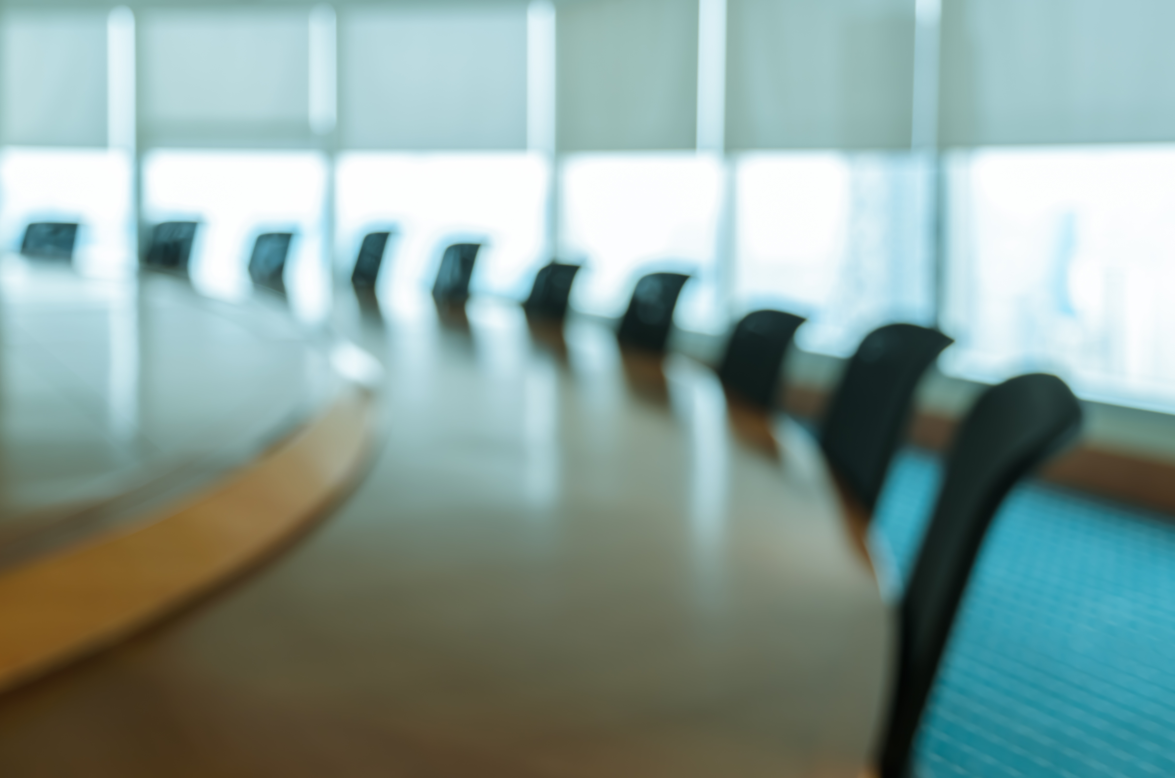 Blur image of empty boardroom with window cityscape background. Business concept