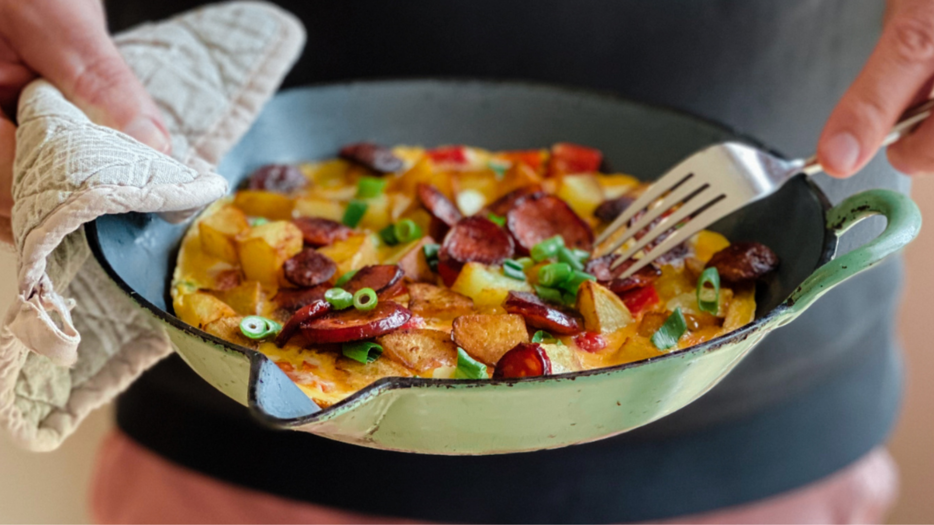 Bratkartoffel Farmers Breakfast holding in pan