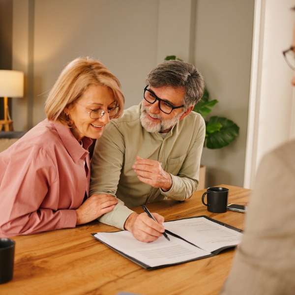 a couple going over paperwork with their loan officer