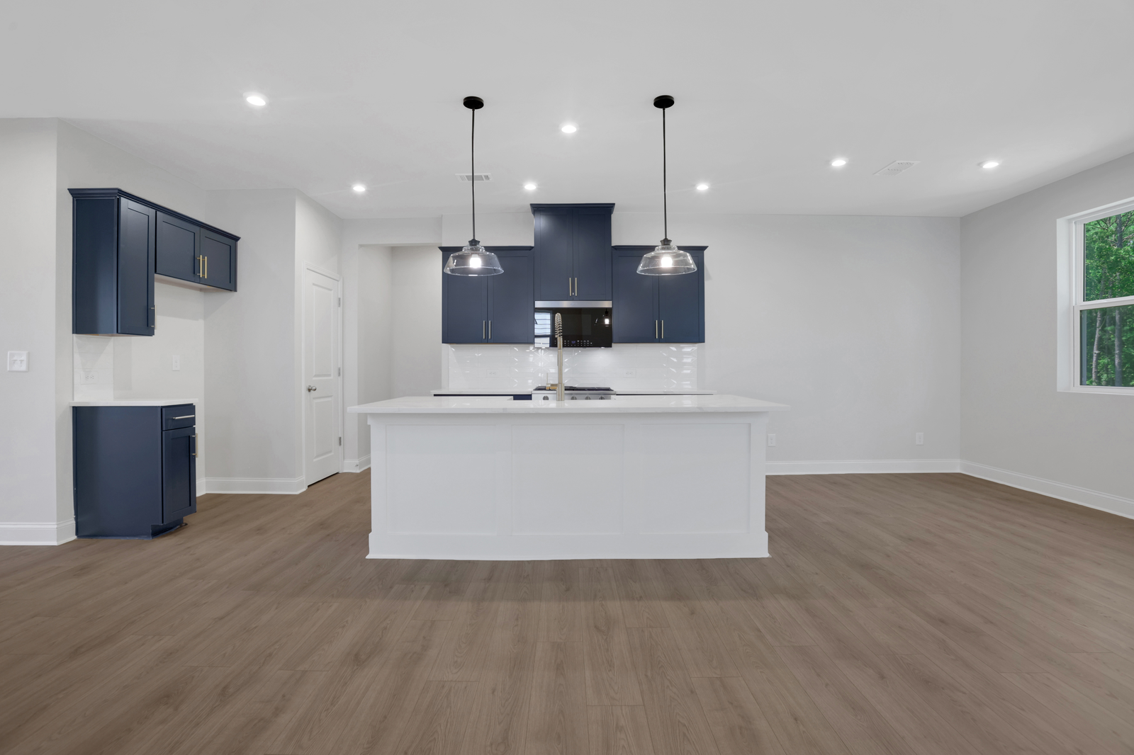 kitchen with navy cabinets and quartz counters