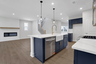 kitchen with navy cabinets and quartz counters