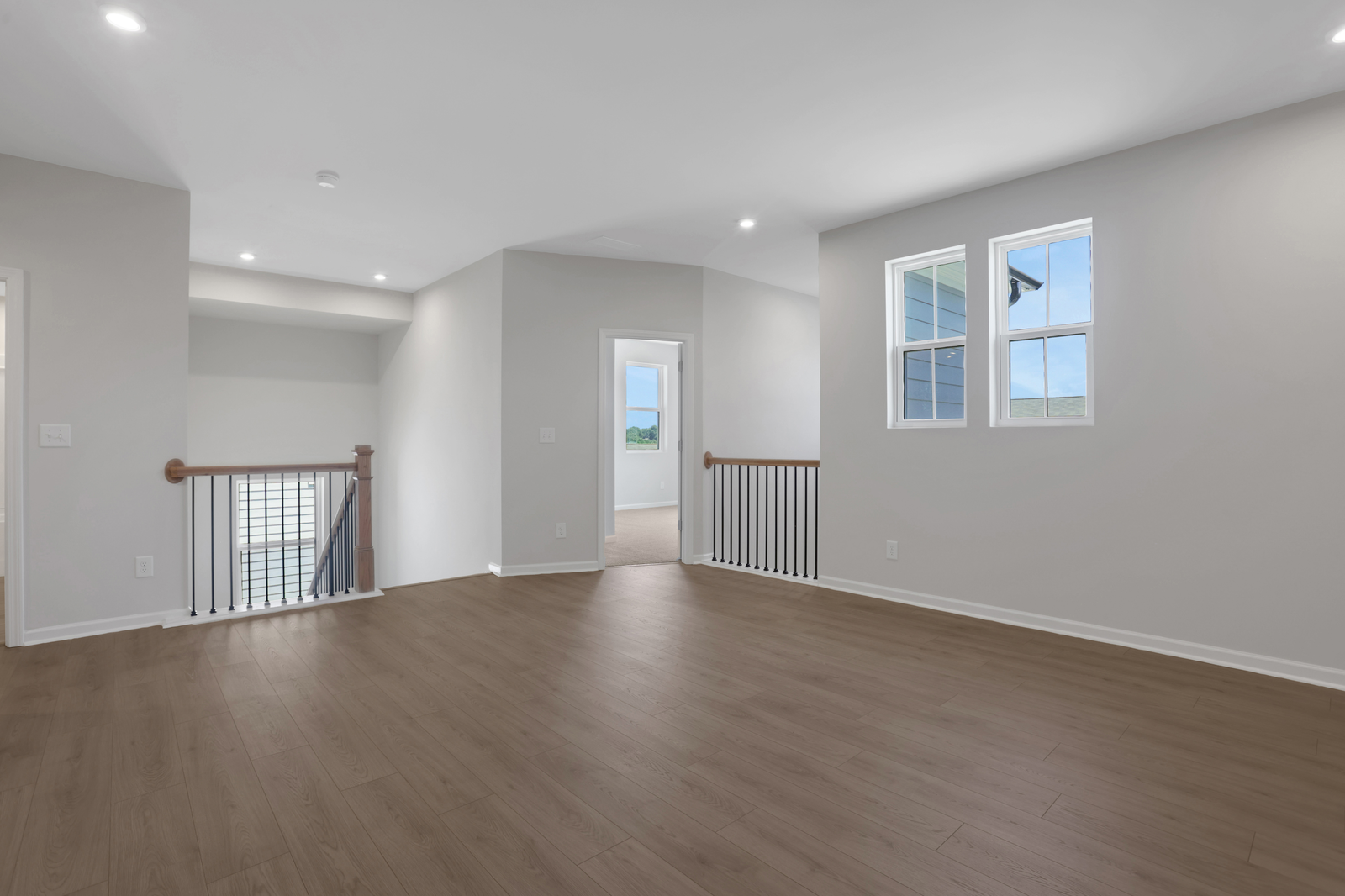 loft with hard surface flooring and windows