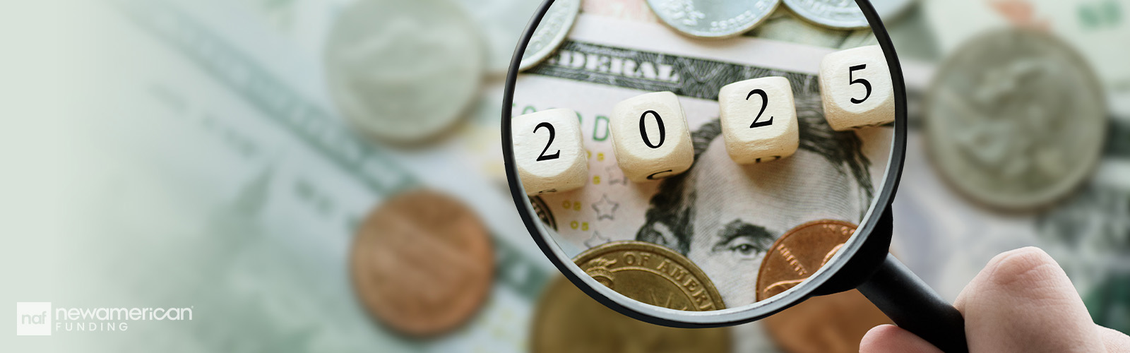 Magnifying glass showing 2025 dice on top of paper money and coins