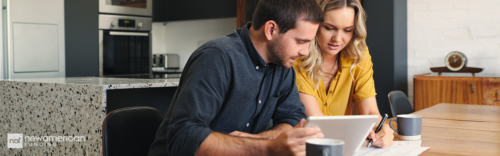 Young couple sitting in front of a computer