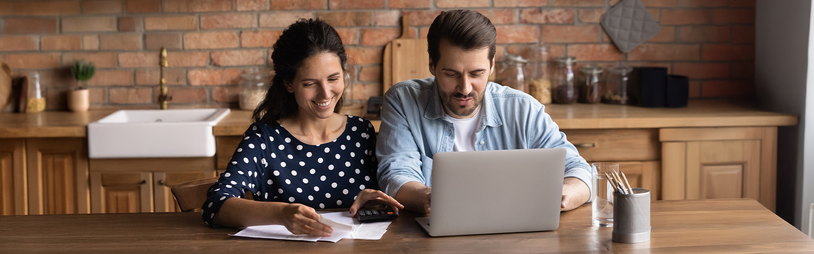 A couple at a computer working on their finances