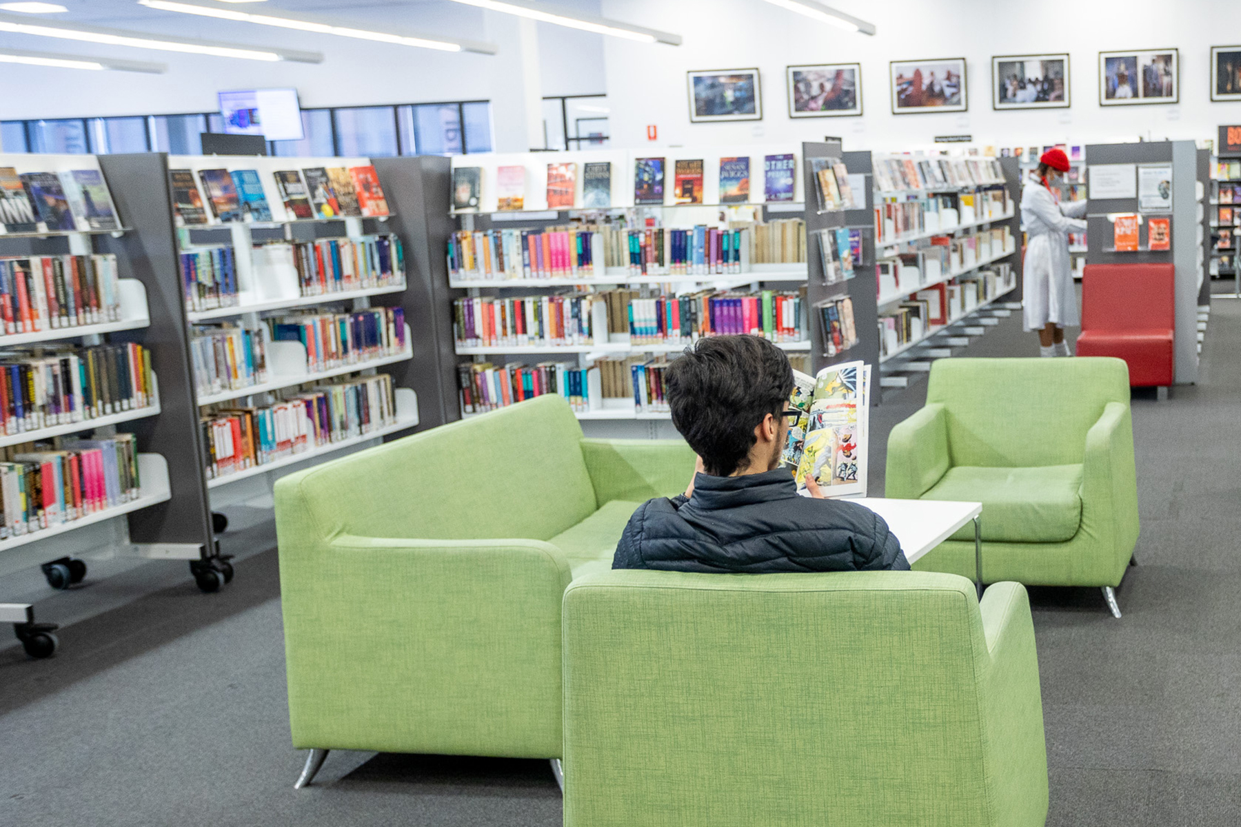 Person sitting on chair in library