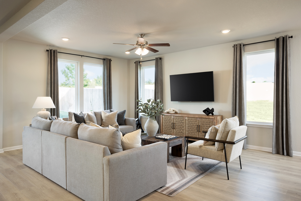 great room with white couches & wood flooring