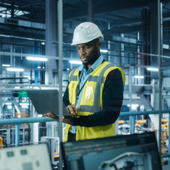 Man in hardhat in manufacturing facility