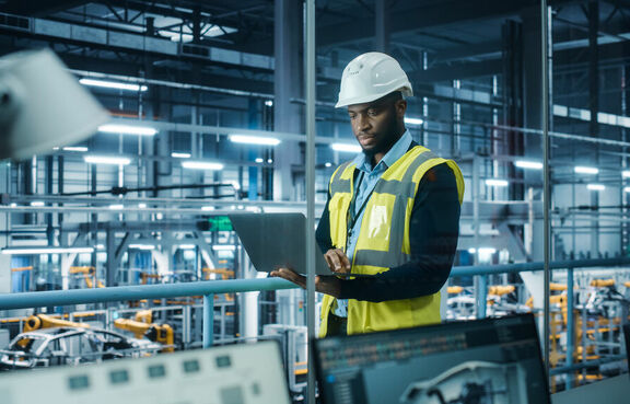 Man in hardhat in manufacturing facility