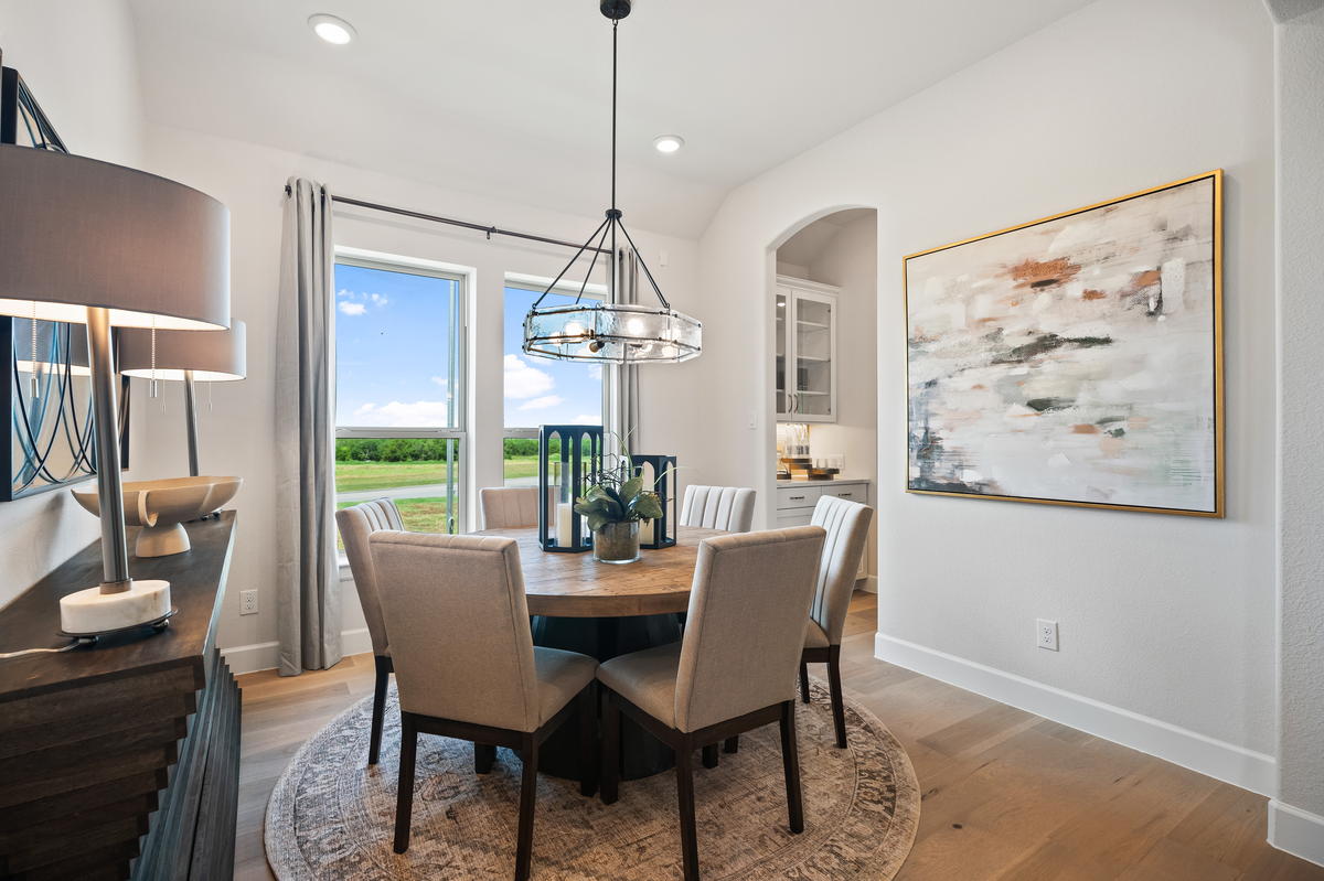 open dining room with wood floors and window