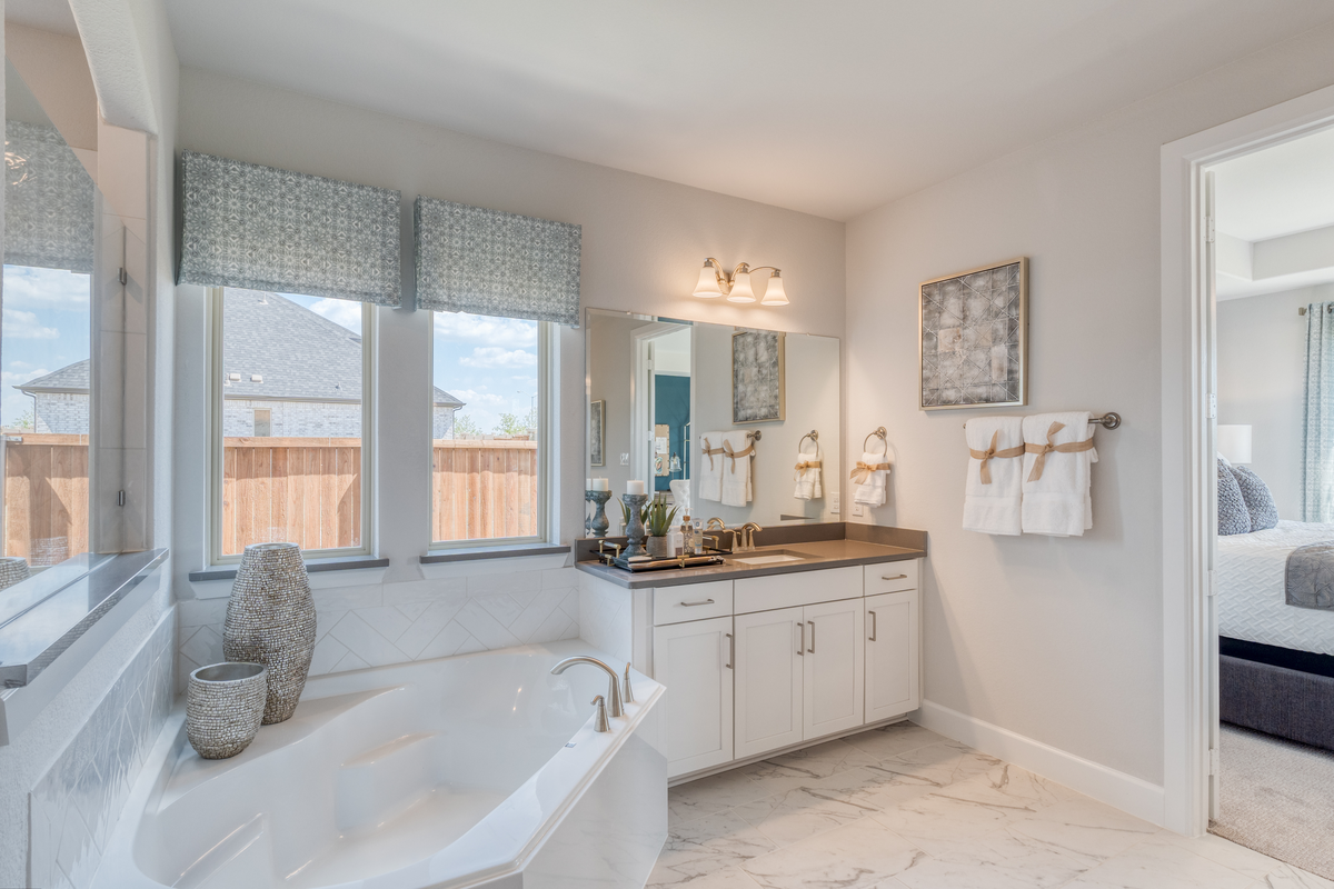 spacious primary bathroom with soaking tub