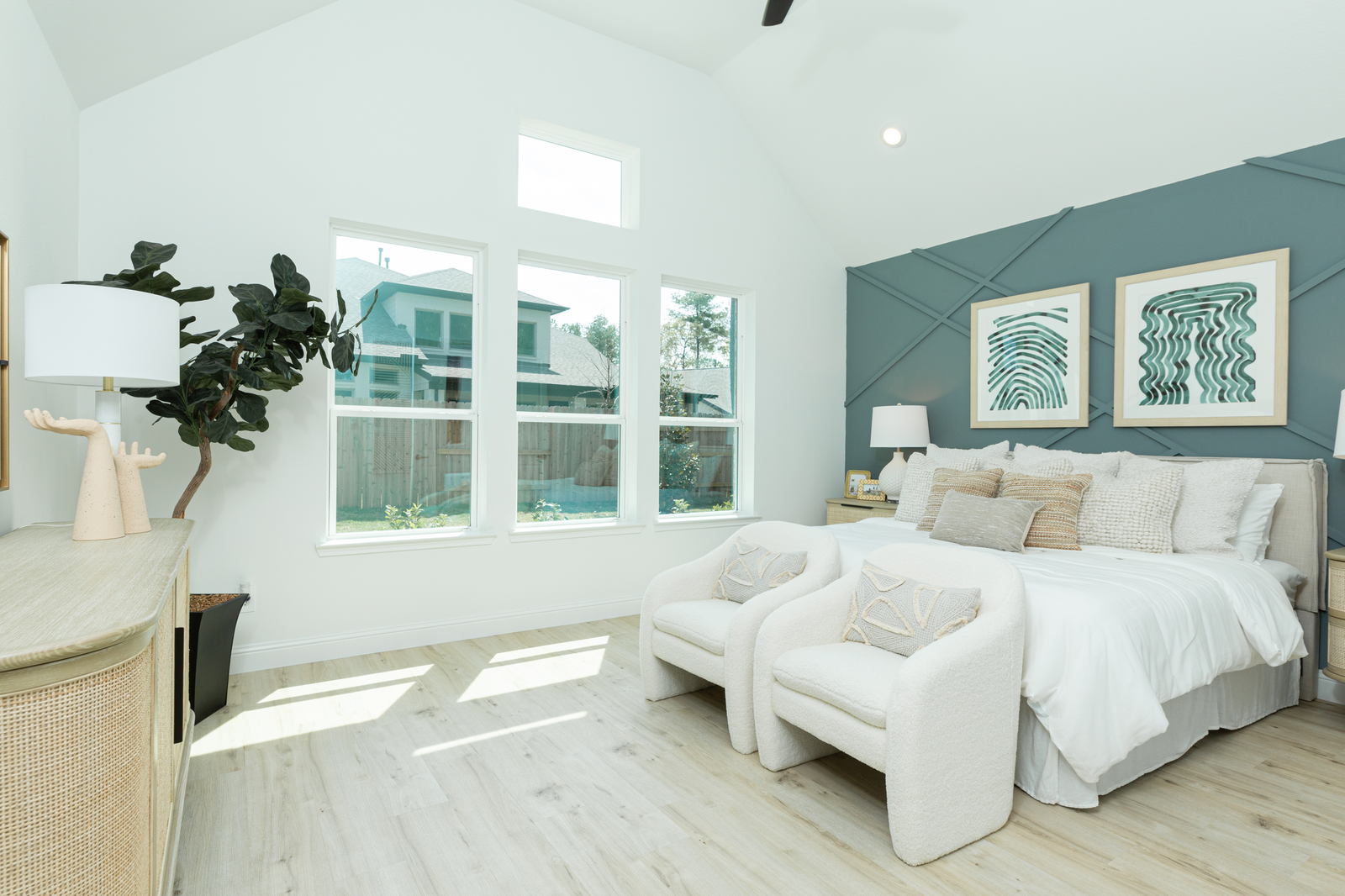 bedroom with high ceiling and large windows