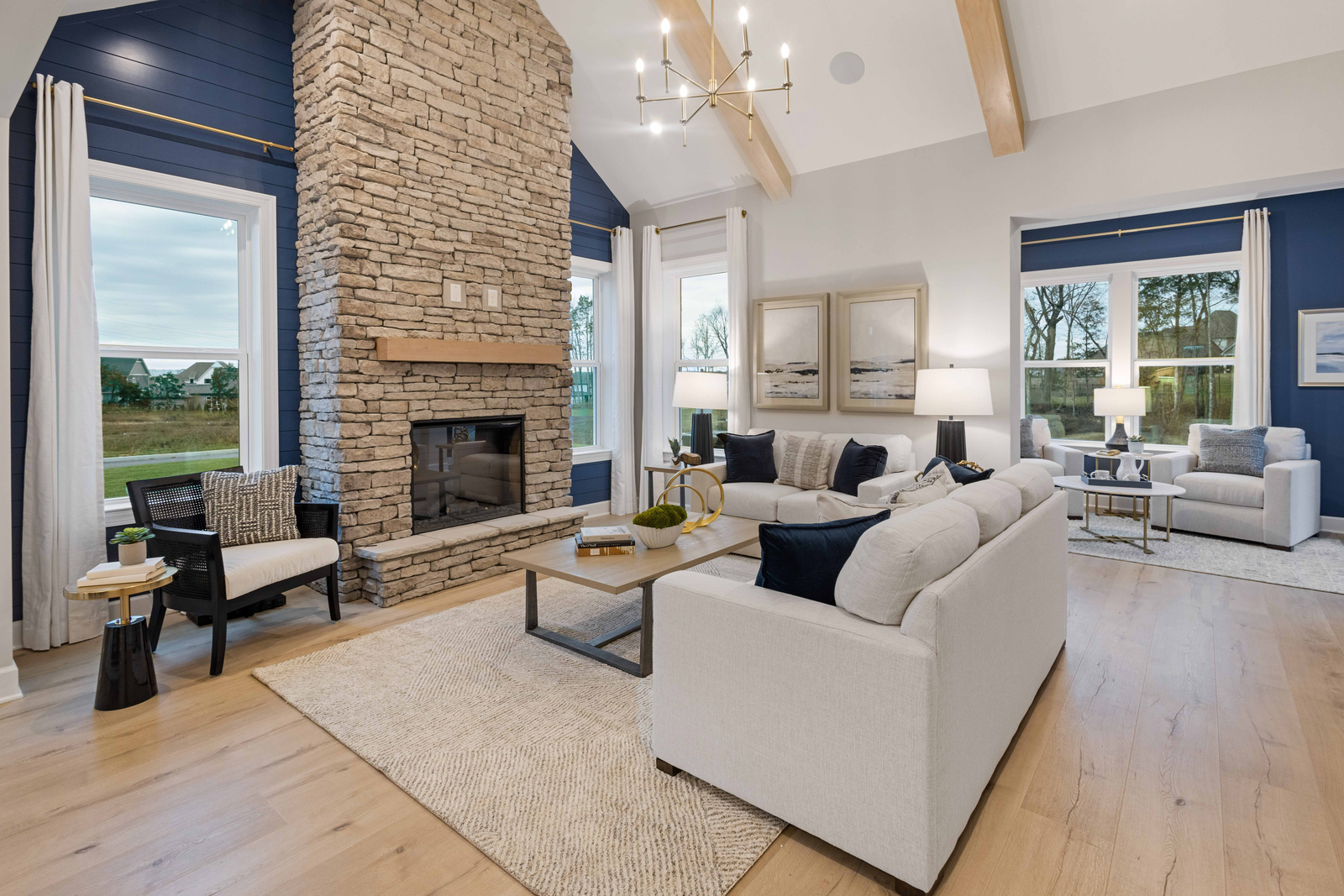 great room with furniture and vaulted ceiling