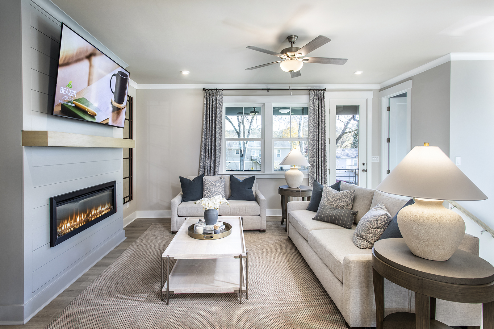great room with electric fireplace and light flooring
