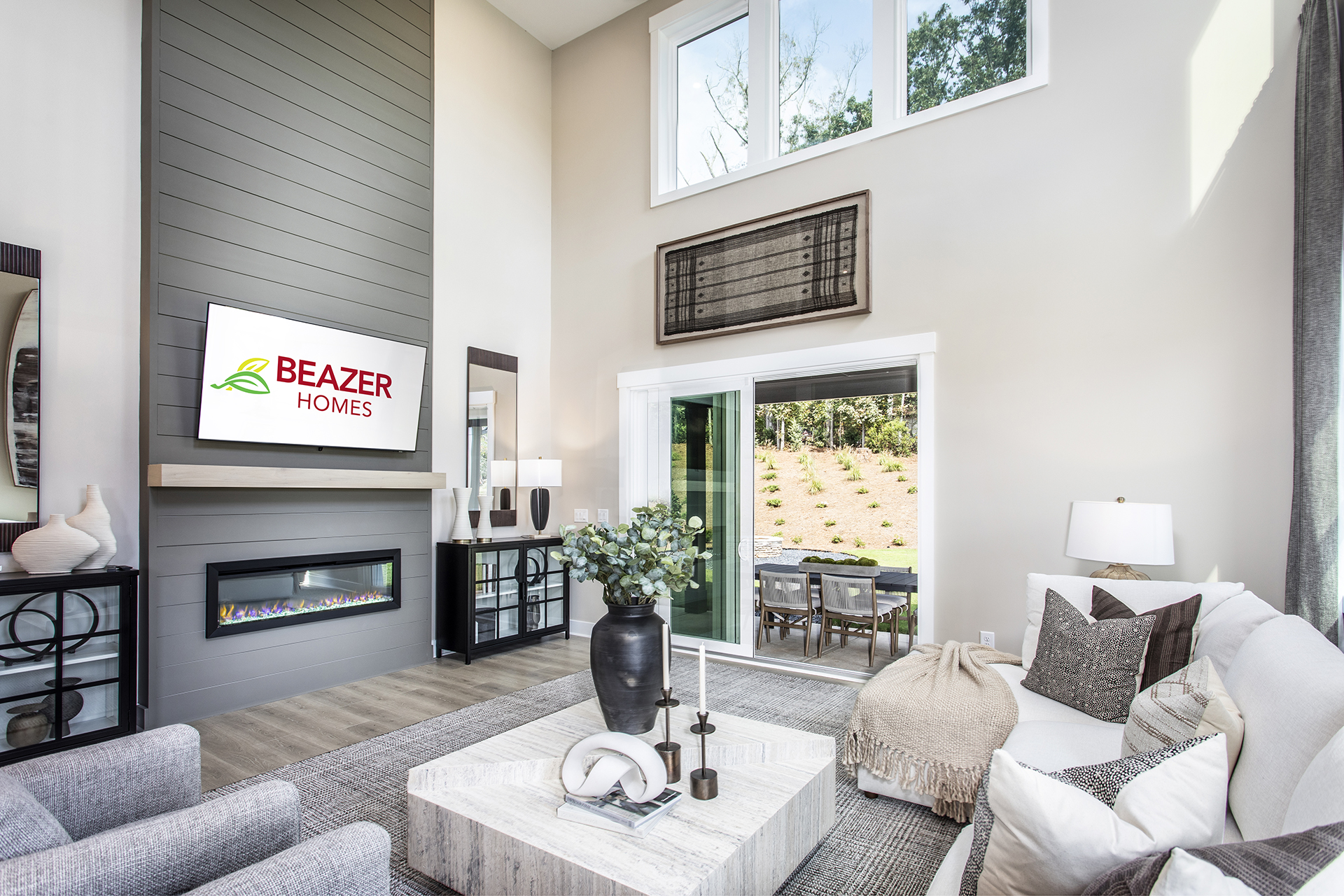 great room with electric fireplace & plank floors