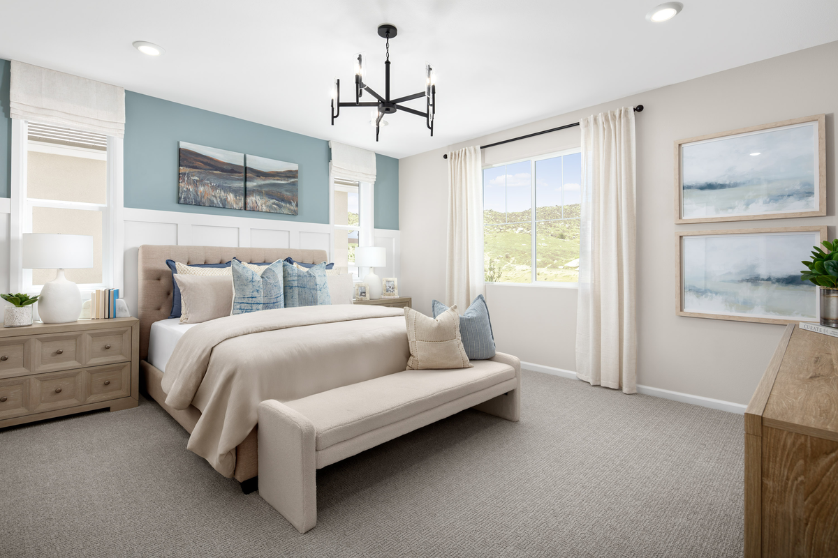 primary bedroom with queen bed and dressers