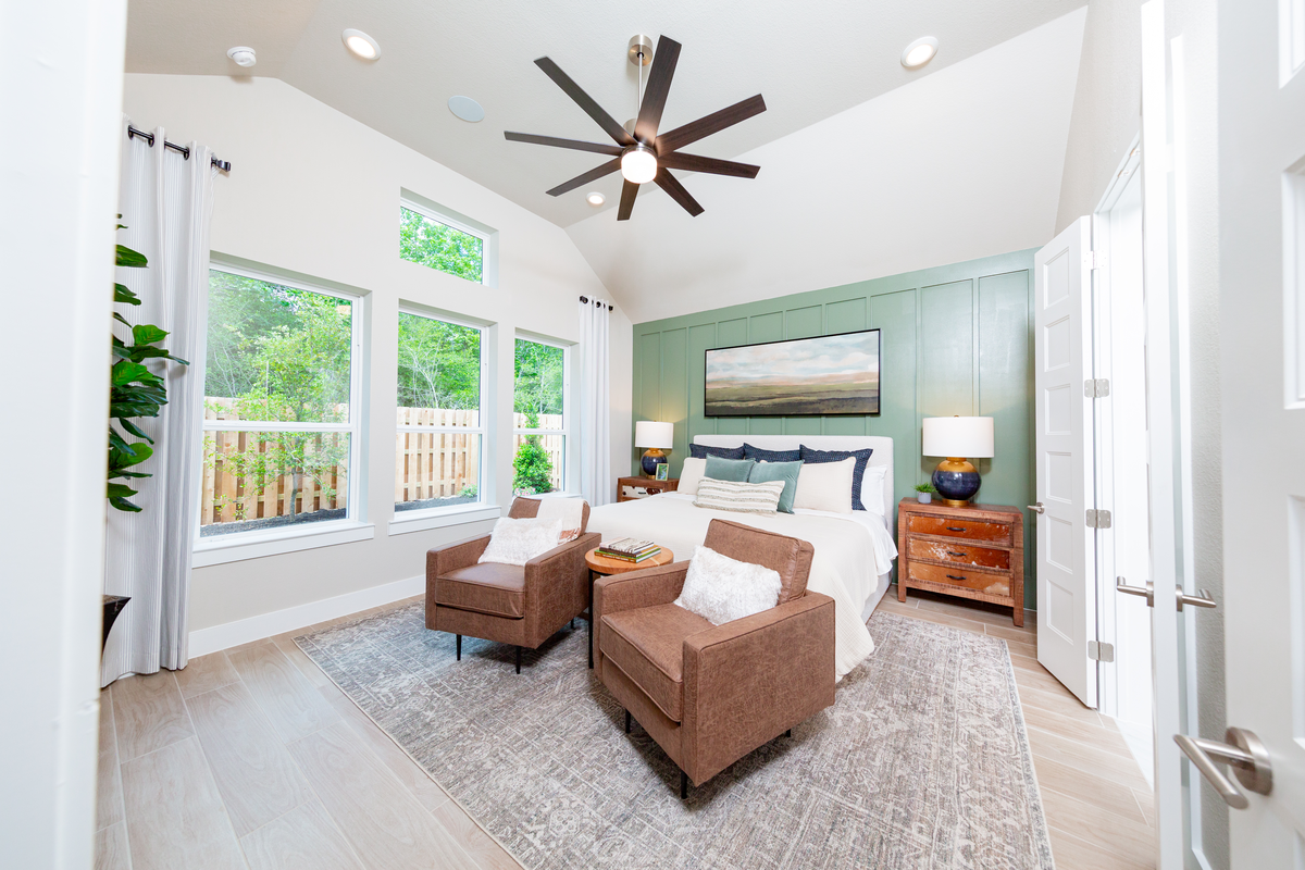 bedroom with high ceilings and tall windows