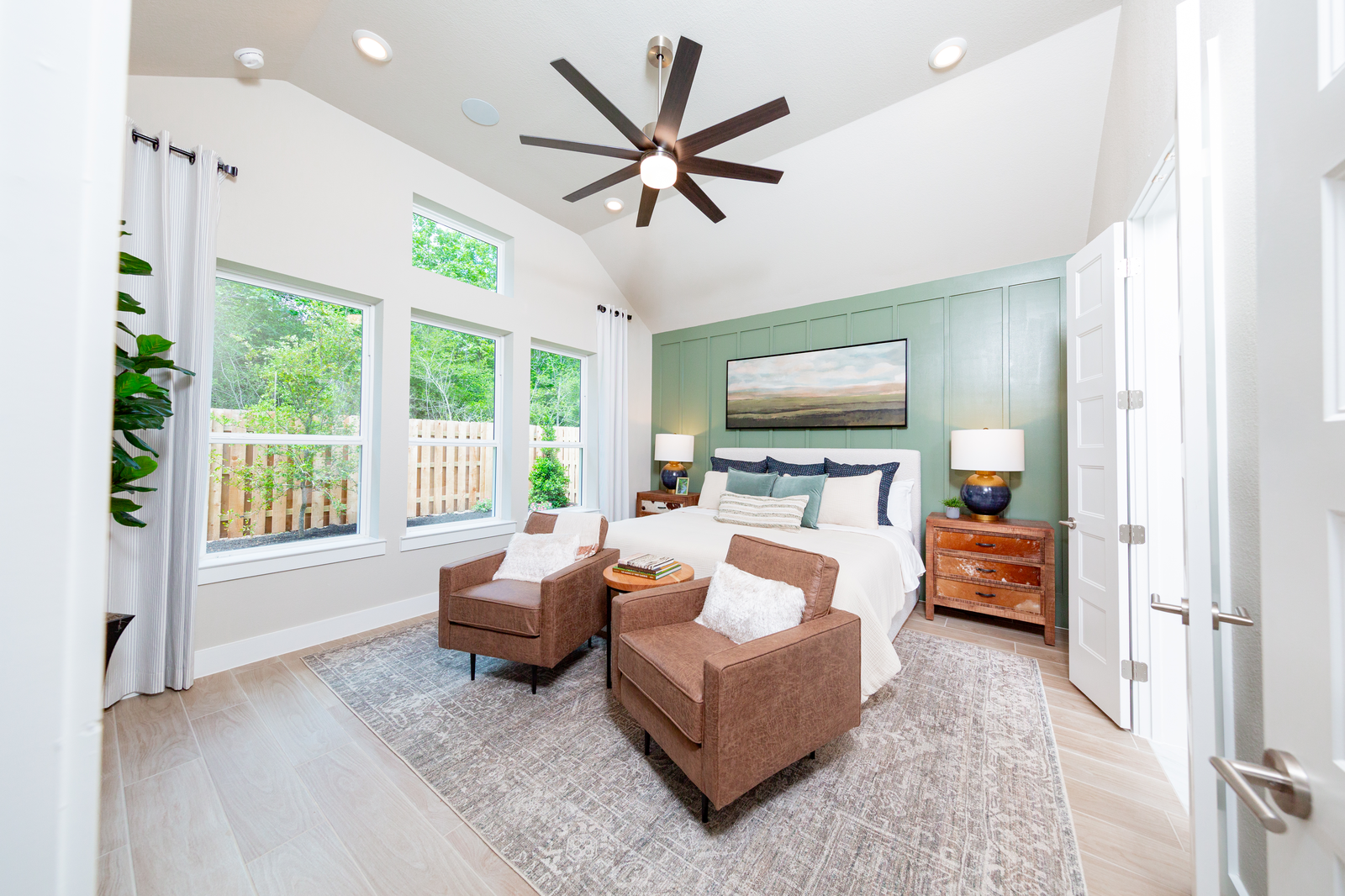 bedroom with high ceilings and tall windows