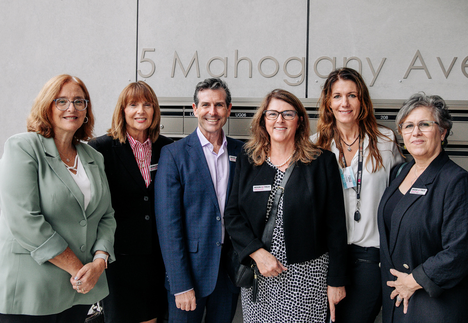 Six Mission Australia representatives standing together in front of a Midtown Macquarie Park building. 
