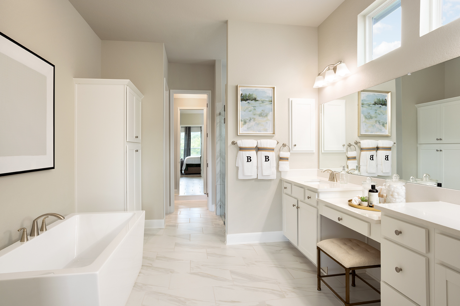 primary bathroom with large tub and dual sinks