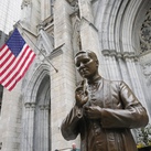 A bronze statue of Blessed Michael McGivney in front of St. Patrick's Cathedral
