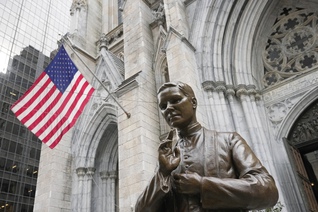A bronze statue of Blessed Michael McGivney in front of St. Patrick's Cathedral