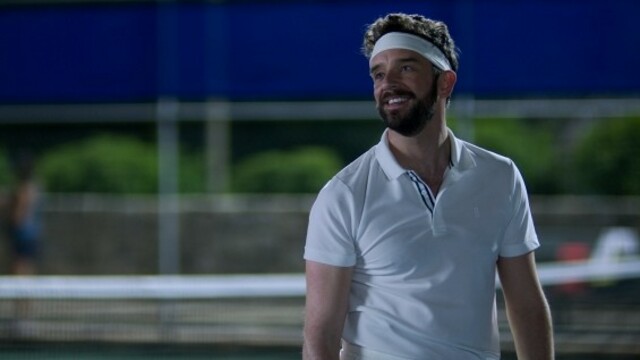 Michael Urie as Brian playing tennis with a white sweatband on in Shrinking