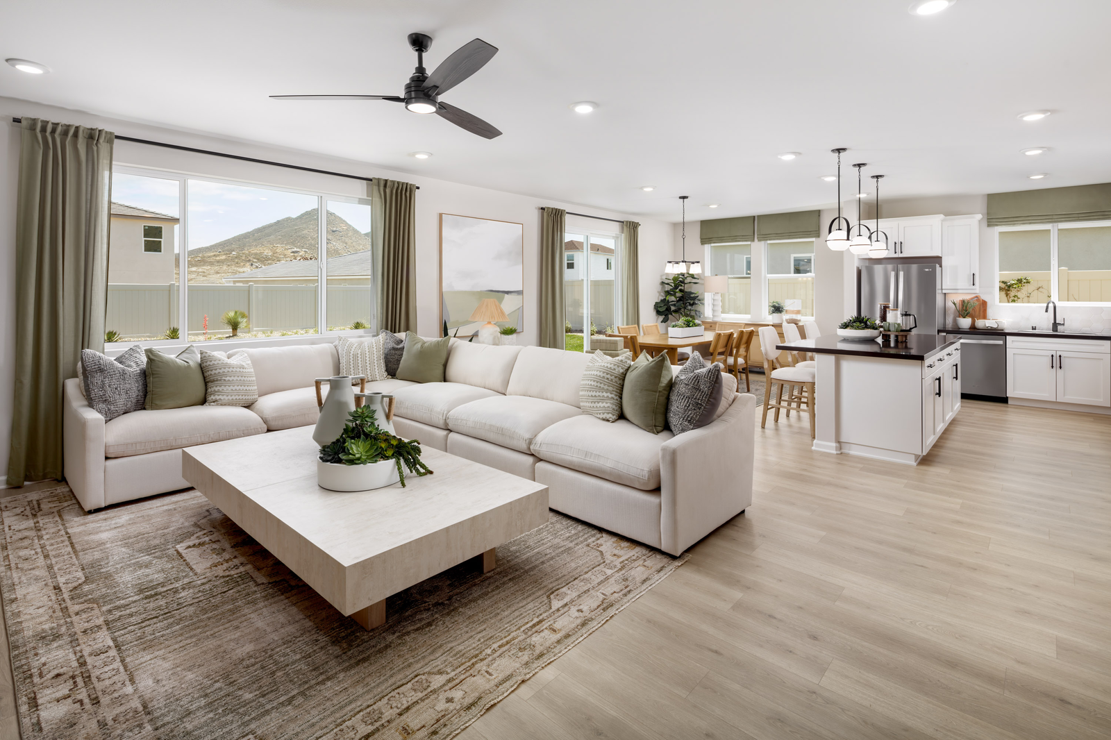 great room with neutral floors and large windows