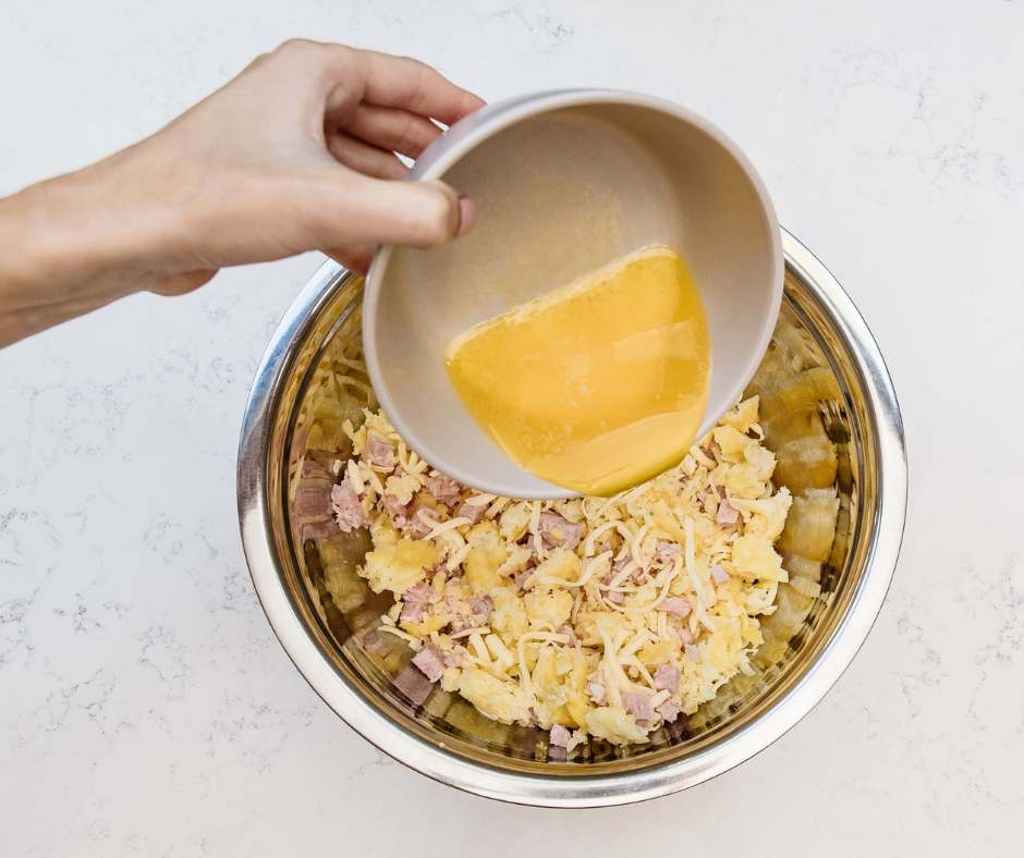 Mothers Day Recipe, Hash Brown Egg Cups Step 1, mix the shredded cheese, hash browns, melted butter, and bacon in a large bowl.