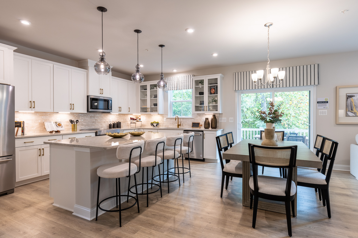 breakfast area with a large table and kitchen