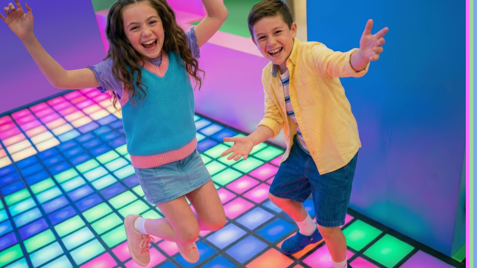 Two children jumping and playing on light up neon play zone floor.