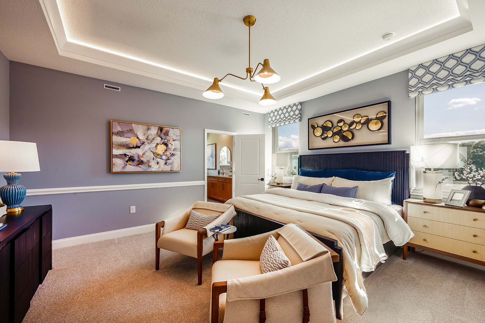 room with carpet throughout, tray ceilings and large windows.