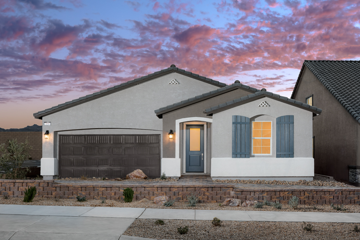 home with desert landscaping and stone driveway
