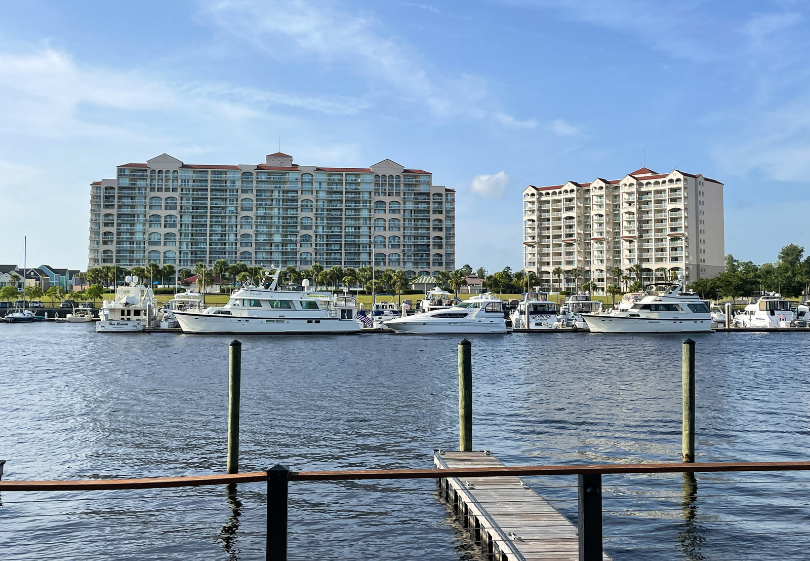 large boats docked in the water beside waterfront condos