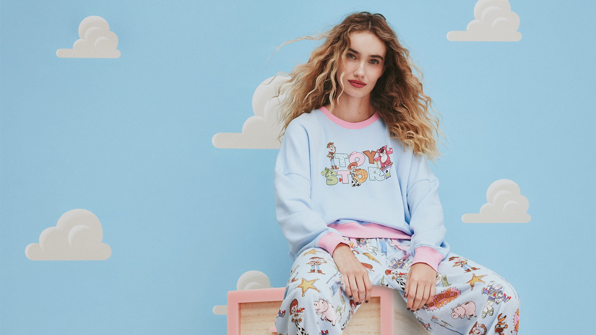 Model wearing a women's Toy Story themed pyjama top and pant from Peter Alexander