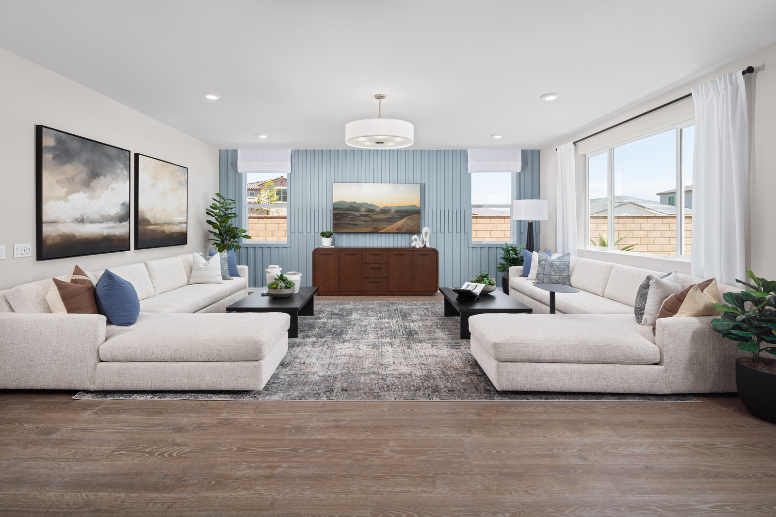 great room with neutral floors and large windows