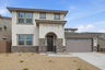 two-story single-family home with desert landscaping and a concrete driveway