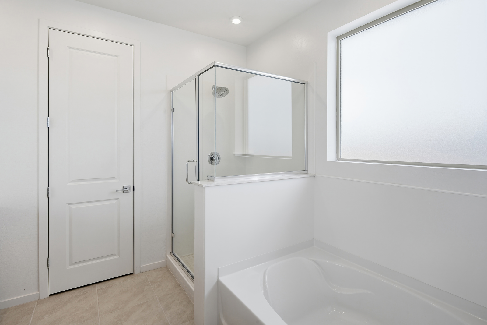 bathroom with a walk-in shower and soaking tub
