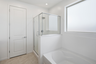 bathroom with a walk-in shower and soaking tub