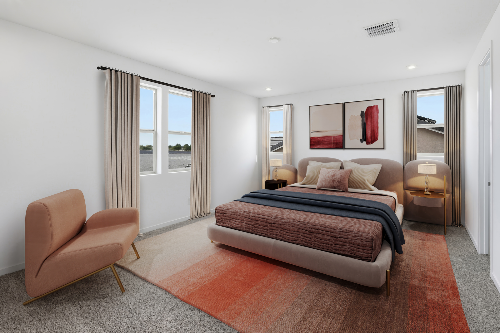 spacious area with a large bed with warm colors and a large rug