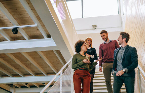 Group of co-workers walking down a staircase 