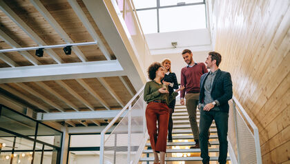 Group of co-workers walking down a staircase 