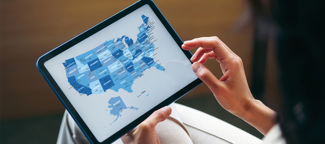 Someone holding a tablet with a map of America.